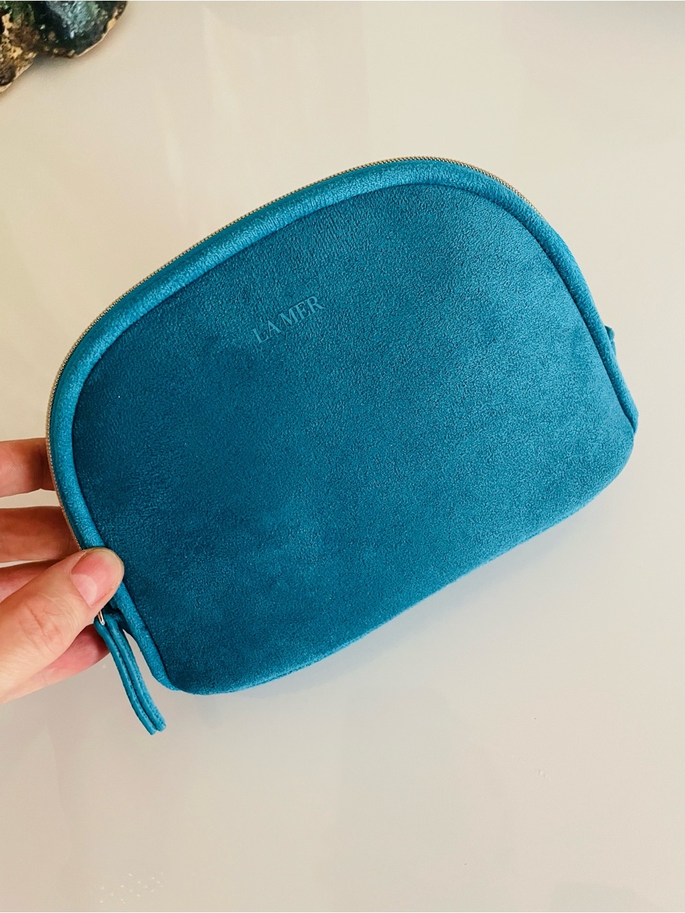 LA MER Teal blue faux Suede Zip Pouch logo